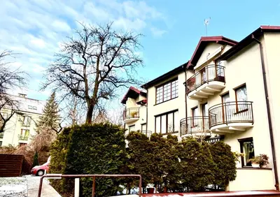 a white building with balconies on the side of it at DM Sunny Apartment - Krakow with free private parking in Kraków