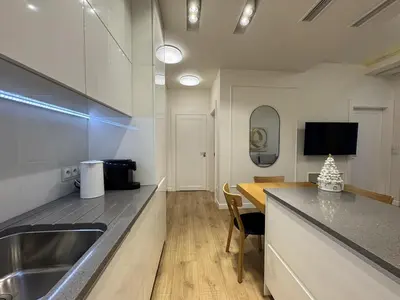 a kitchen with a sink and a counter top at Old Town Apt with AC & Parking, 5 min Main Sq & Kazimierz in Kraków