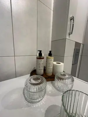 a small bathroom with a sink and a mirror at ApAzory Kraków - przytulny apartament na wyłączność in Kraków