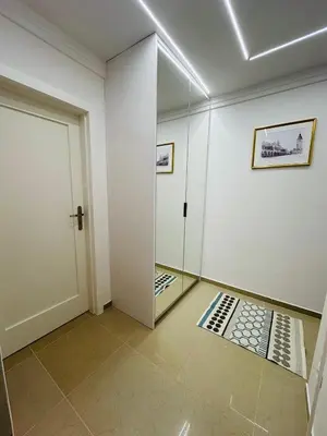 a bedroom with a bed and a chandelier at ApAzory Kraków - przytulny apartament na wyłączność in Kraków