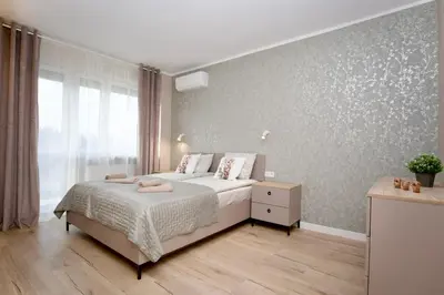 a bedroom with a bed and a wall with stars at Łagiewniki Apartments Free Parking in Kraków