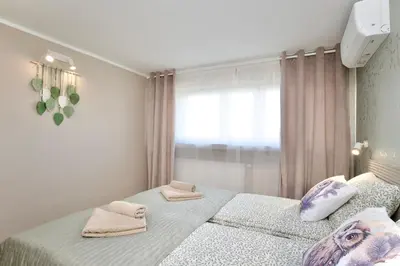 a bedroom with two beds with towels on them at Łagiewniki Apartments Free Parking in Kraków
