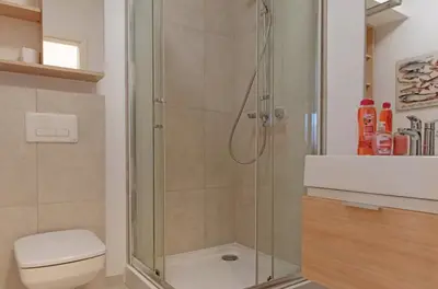 a bathroom with a shower with a toilet and a sink at Castor in Kraków