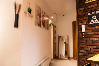 a room with a brick wall and a hallway at Soniya's Castle View Apartment in Kraków