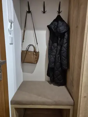 a bench with a bag and a purse at Kobierzyńska Apartments in Kraków