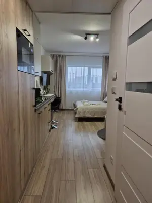 a bedroom with a bed and a desk in a room at Kobierzyńska Apartments in Kraków