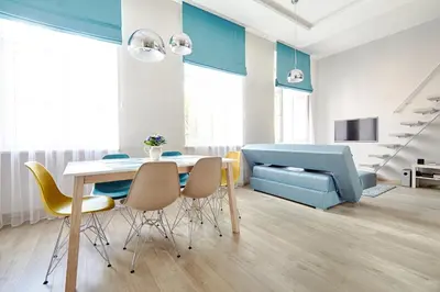 a living room with a table and chairs and a couch at Central Krak Apartments in Kraków