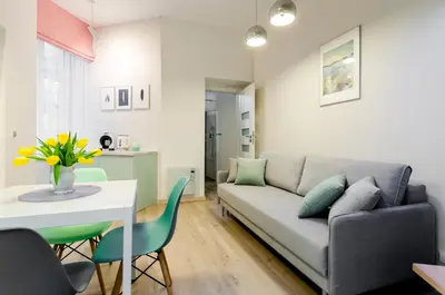 a living room with a couch and a table at Central Krak Apartments in Kraków