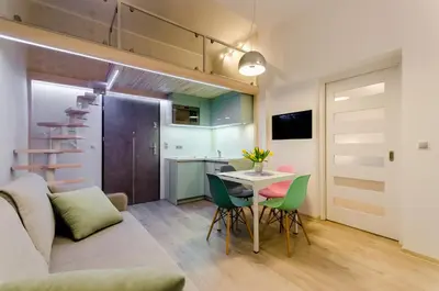 a living room with a couch and a table and chairs at Central Krak Apartments in Kraków