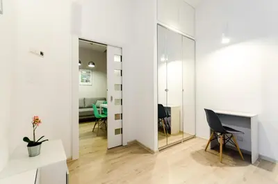 a room with a table and a chair and a mirror at Central Krak Apartments in Kraków