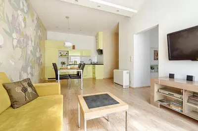 a living room with a couch and a dining room at Central Krak Apartments in Kraków