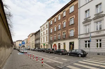 a street with cars parked on the side of the road at Apartment for two - Krowoderska 21 street in Kraków