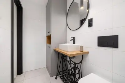 a bathroom with a sink and a mirror at Apartment for two - Krowoderska 21 street in Kraków