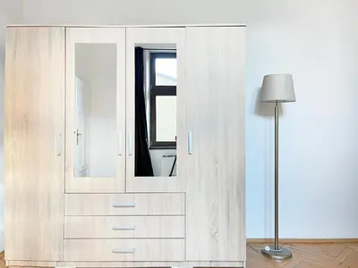 a kitchen with wooden cabinets and a white refrigerator at Cultural Hot Spot - Old Town in Kraków