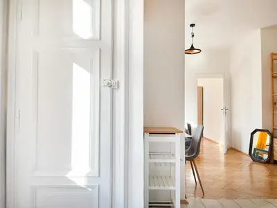 a kitchen with wooden cabinets and a white refrigerator at Cultural Hot Spot - Old Town in Kraków