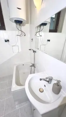 a white bathroom with a sink and a toilet at Cultural Hot Spot - Old Town in Kraków
