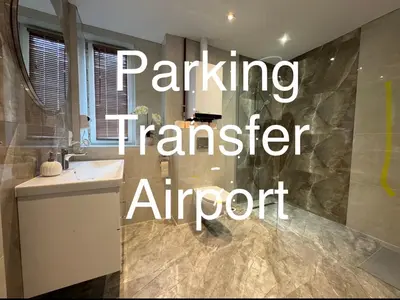 a bathroom with a sink and a shower with the words parking transfer airport at AMBER PENSJONAT LOTNISKO PARKINg