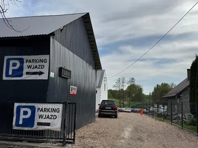a parking garage with a car parked next to a building at AMBER PENSJONAT LOTNISKO PARKINg