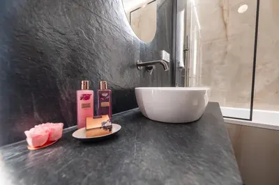 a bathroom with a counter with a sink and a sink at Clermont Apartment by Cracovia Prime in Kraków