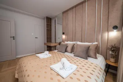 a bedroom with a large bed with towels on it at Clermont Apartment by Cracovia Prime in Kraków