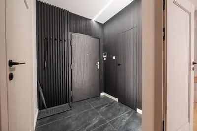 a hallway with black walls and a door at Clermont Apartment by Cracovia Prime in Kraków