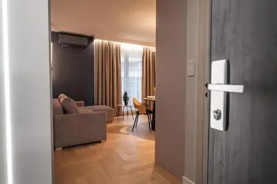 a living room with a couch and a table at Clermont Apartment by Cracovia Prime in Kraków