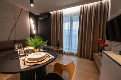 a living room with a table and a couch at Clermont Apartment by Cracovia Prime in Kraków