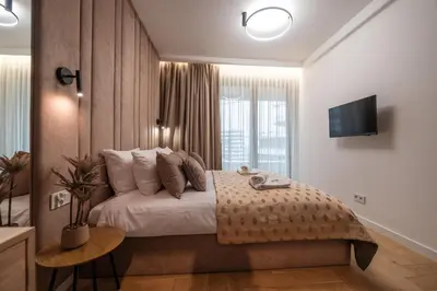 a bedroom with a large bed and a window at Clermont Apartment by Cracovia Prime in Kraków