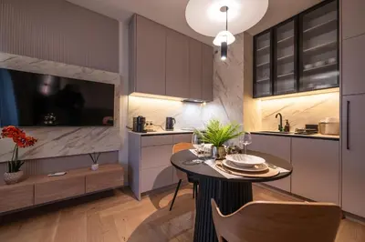 a kitchen with a table and a dining room at Clermont Apartment by Cracovia Prime in Kraków