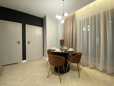 a dining room with a black table and chairs at Apartament przy Rakowickiej IV Old Town in Kraków