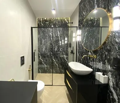 a bathroom with a sink and a shower with a mirror at Apartament przy Rakowickiej IV Old Town in Kraków