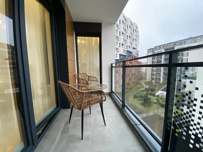 a balcony with two chairs and a table at Apartament przy Rakowickiej IV Old Town in Kraków