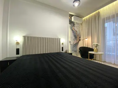 a bedroom with a large bed and a window at Apartament przy Rakowickiej I Old Town in Kraków