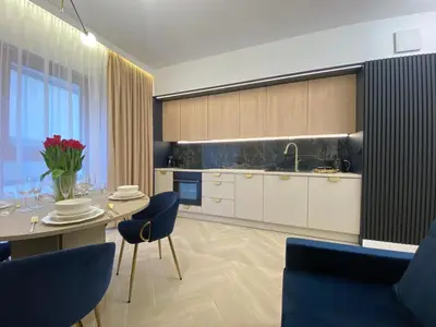 a kitchen with a table and chairs and a dining room at Apartament przy Rakowickiej I Old Town in Kraków