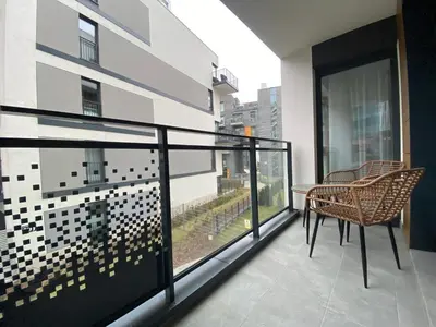 a balcony with a table and chairs on a building at Apartament przy Rakowickiej I Old Town in Kraków