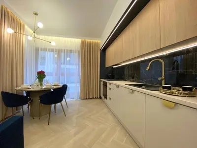 a kitchen with a table and a dining room at Apartament przy Rakowickiej I Old Town in Kraków