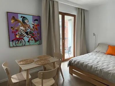 a bedroom with a bed and a table and a tableablish at Art Studio Rakowicka in Kraków
