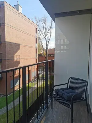 a bench sitting on a balcony next to a building at Art Studio Rakowicka in Kraków