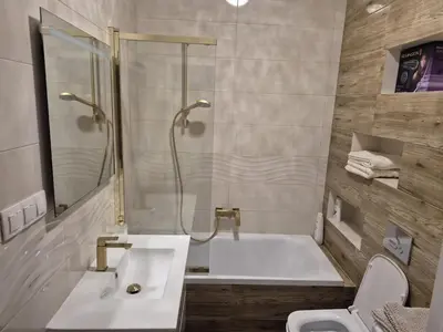 a bathroom with a tub and a sink and a toilet at Art Studio Rakowicka in Kraków