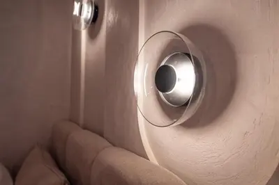 a wall with a circular object in a room at Fleurmont Apartment by Cracovia Prime in Kraków