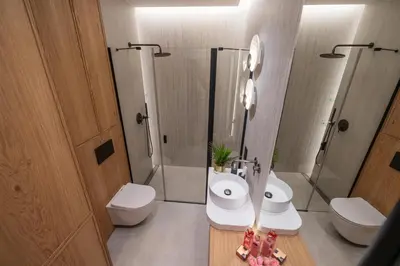 a bathroom with a toilet and a sink and a shower at Fleurmont Apartment by Cracovia Prime in Kraków