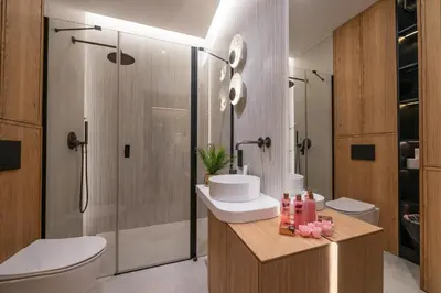 a bathroom with a toilet and a sink and a shower at Fleurmont Apartment by Cracovia Prime in Kraków