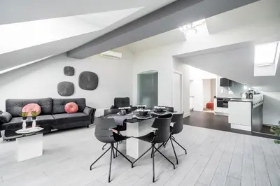 a living room with a couch and a table and chairs at Krzyża Residence in Kraków