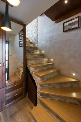 a staircase in a room with a stone wall at Krzyża Residence in Kraków