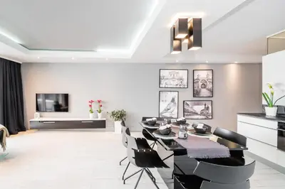 a living room with a dining table and chairs at Krzyża Residence in Kraków
