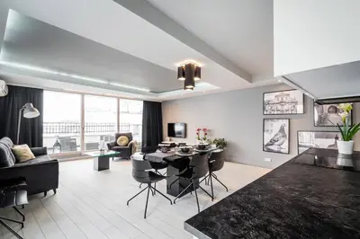 a living room with a table and a dining room at Krzyża Residence in Kraków