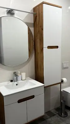 a bathroom with a white sink and a mirror at MICKIEWICZ HOUSE Apartamenty in Wadowice
