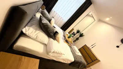 a large couch in a room with a window at MICKIEWICZ HOUSE Apartamenty in Wadowice