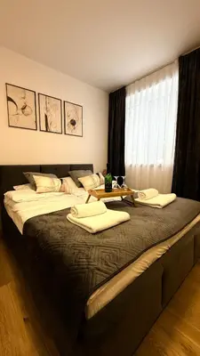 a bedroom with a large bed with a table on it at MICKIEWICZ HOUSE Apartamenty in Wadowice