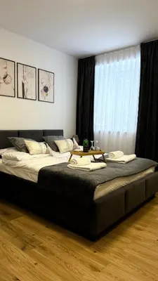 a bedroom with a large bed with a table on it at MICKIEWICZ HOUSE Apartamenty in Wadowice